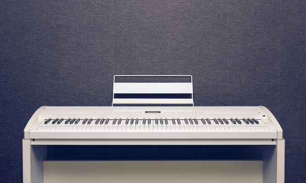Digital piano over gray wall - Photo, Image