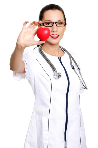 Female doctor holding red heart in hand - 写真・画像