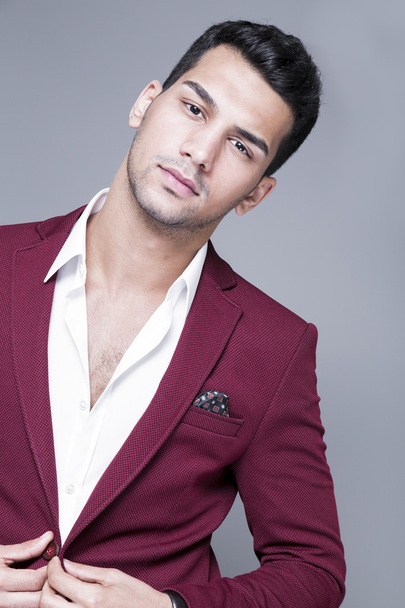 Young and attractive middle eastern man portrait in suits on gray background, studio shot - 写真・画像