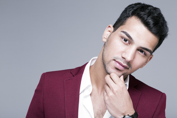 Young and attractive middle eastern man portrait in suits on gray background, studio shot - Photo, Image