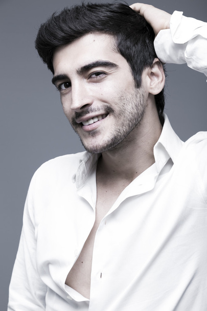 Young and handsome middle eastern man on grey background, studio portrait - Foto, afbeelding