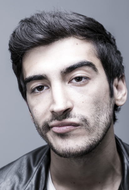Young and handsome middle eastern man on grey background, studio portrait - Фото, изображение