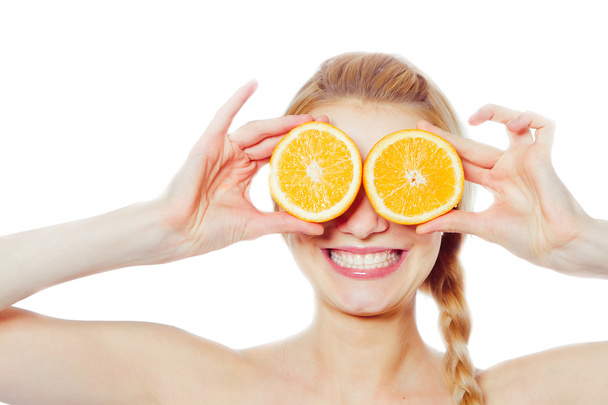 Young woman with oranges - Foto, imagen