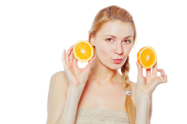Young woman with oranges - Foto, Imagen