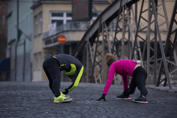 couple warming up before jogging - Photo, Image