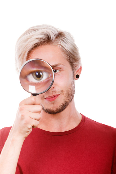man holds on eye magnifying glass looking through loupe - Foto, Bild