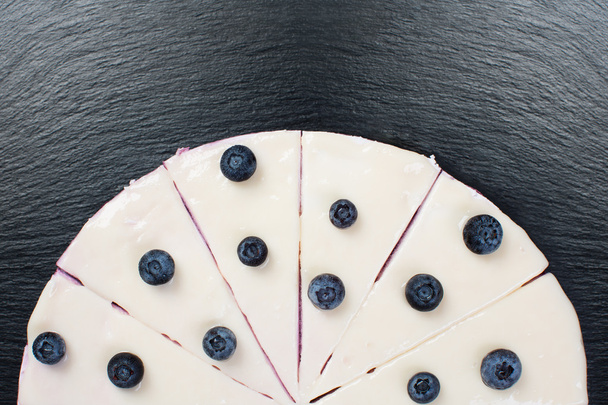 Curd cake with white icing and wineberry. - Valokuva, kuva