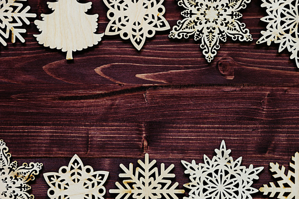 Christmas soft beige wooden snowflakes on a vintage wood brown  background. - Foto, afbeelding