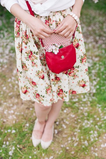 Closeup red bag in hands of woman on the street  - Foto, Imagem