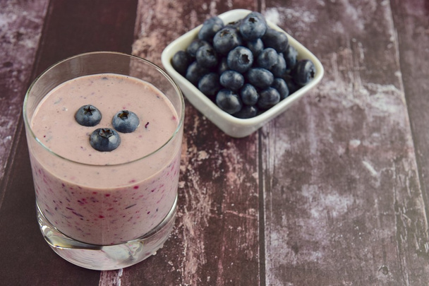 Blueberry smoothie on wooden background - Fotoğraf, Görsel