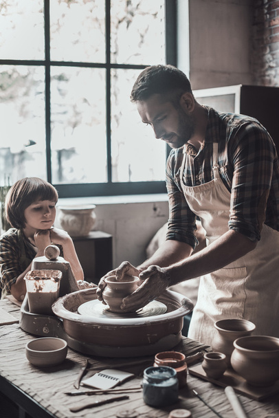 father and son making ceramic pot - Фото, изображение