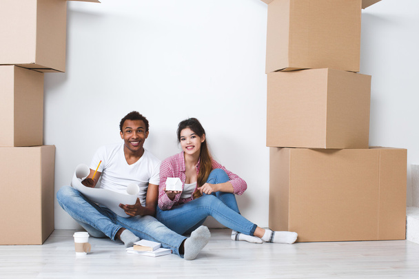 Couple sitting on the floor new house after moving.  - Photo, Image