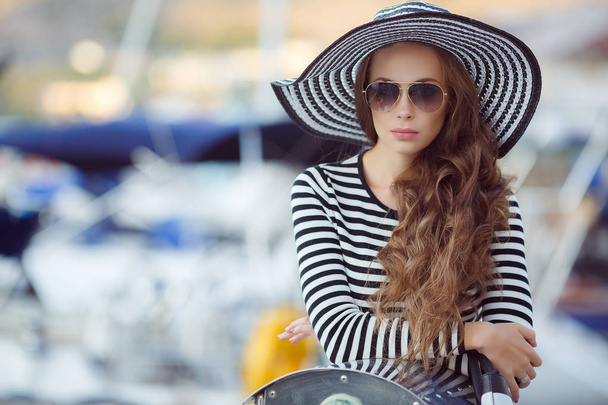 Portrait of beautiful woman in hat on the pier - Фото, зображення