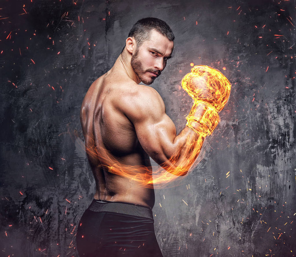 Shirtless fighter with burning boxer glove. - Photo, Image