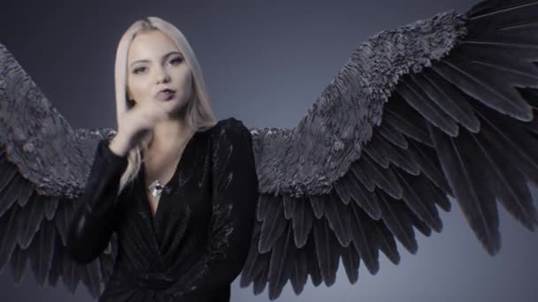 Blonde girl in a black dress and with wings - Footage, Video