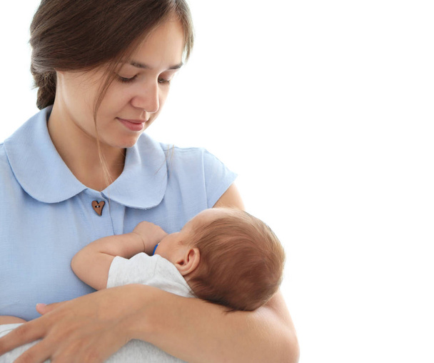 Portrait of pretty young woman holding her baby, isolated on white - Φωτογραφία, εικόνα
