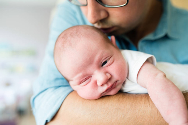 Close up, unrecognizable father holding his newborn baby son - Foto, Imagen