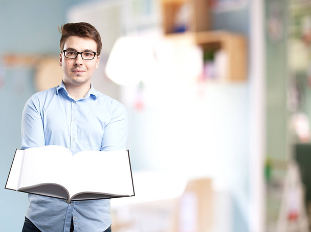 happy young man with small book - Photo, Image