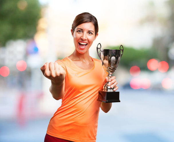 proud sport woman with sport cup - Foto, imagen