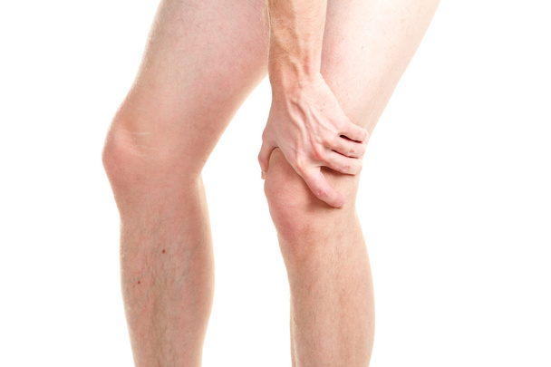 man holding sore knee, isolated on white - Photo, Image