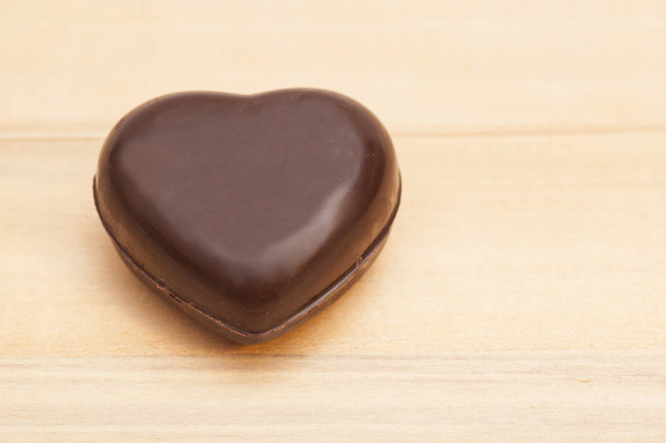 Chocolate heart on wooden background - Photo, Image