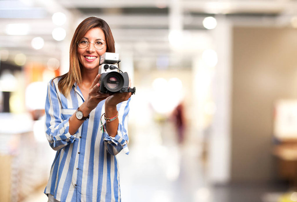 happy young woman with movie camera - Фото, изображение