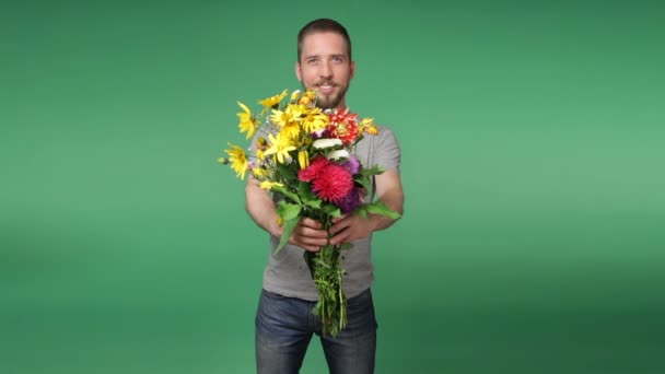 Young romantic man giving a bouquet of flowers - Felvétel, videó