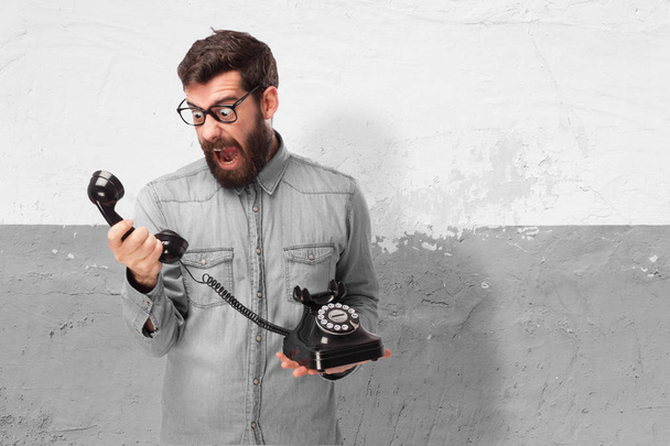 angry young man with telephone - Foto, Bild