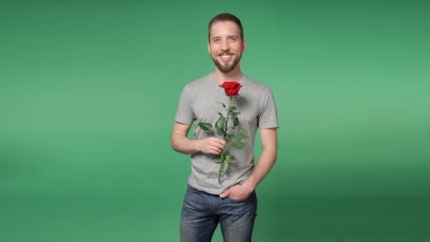 Young romantic man giving a red rose - Felvétel, videó