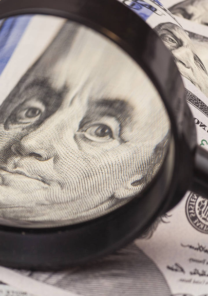 Hundred dollar banknotes under magnifying glass  - Foto, Imagen