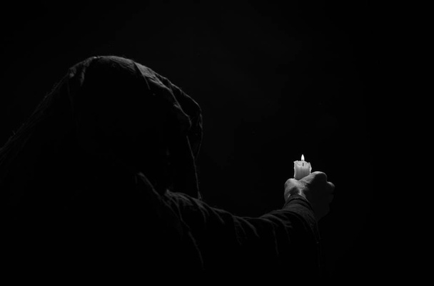 Monk with candle. - Foto, Imagen