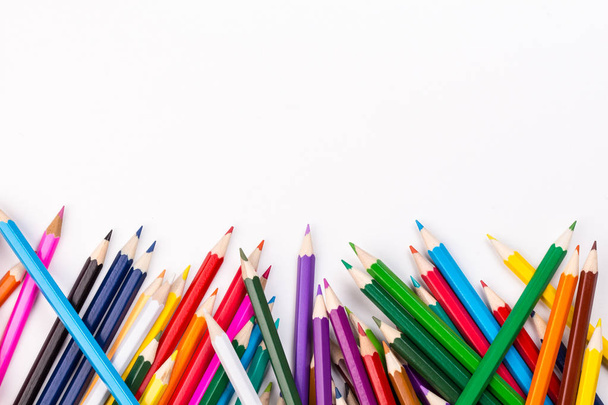 Color pencils topsy-turvy pile with white space - Fotó, kép