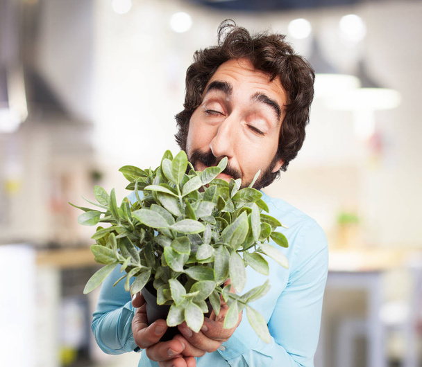 happy young man with plant - Fotoğraf, Görsel