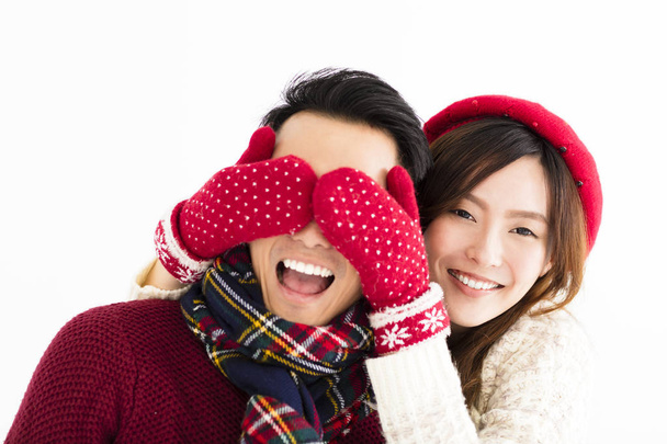 happy couple in winter wear and covering eyes to surprised  - Foto, imagen