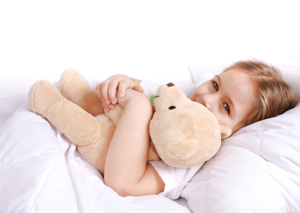 Cute girl cuddling with teddy bear - Fotó, kép