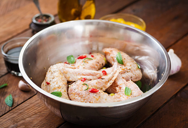 Raw marinated chicken wings on bowl - Photo, Image