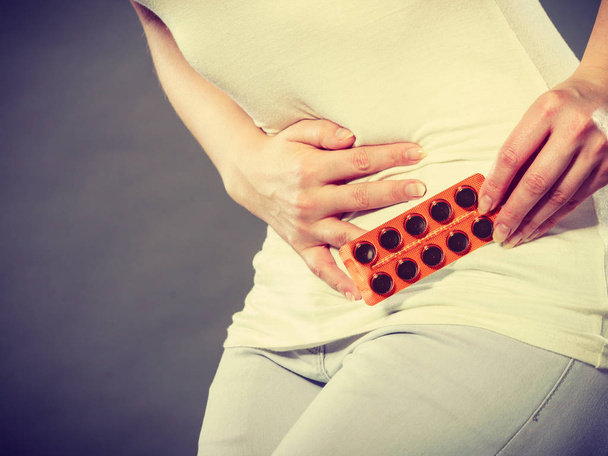 Woman suffer from belly pain holds pills - Zdjęcie, obraz