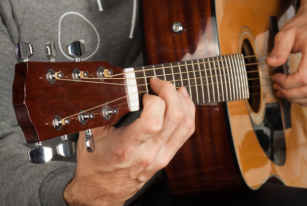 Man's hand playing the guitar.  - Zdjęcie, obraz