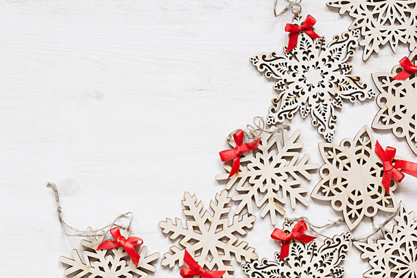 Christmas soft beige wooden snowflakes on a wood white  background.  - 写真・画像