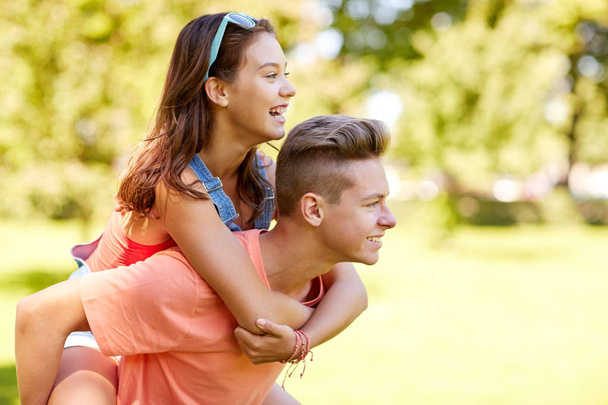 happy teenage couple having fun at summer park - Foto, Imagem