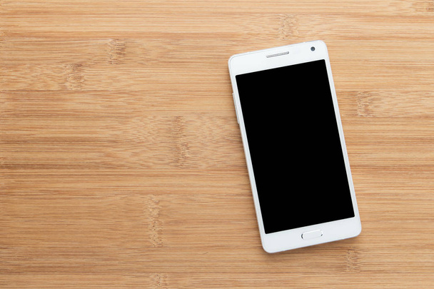 Fehér intelligens telefon-val a régi fa elszigetelt képernyő - Fotó, kép