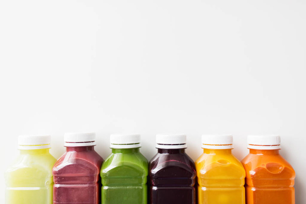 bottles with different fruit or vegetable juices - Foto, afbeelding
