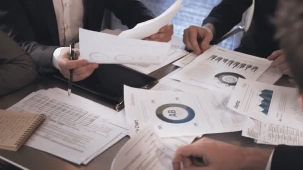 Business people exchanging documents, closeup shot - Кадри, відео
