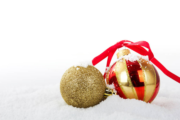 Gold Christmas decorations in white snow for background - Фото, зображення