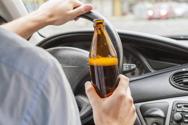 transportation and vehicle concept - man drinking alcohol while  driving the car - Foto, Imagen
