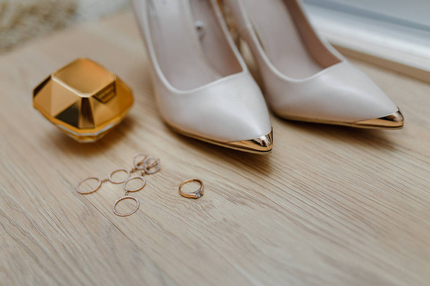 Wedding bridal accessories shoes, jewelry, perfume bottle, wedding rings with copy space - Photo, Image
