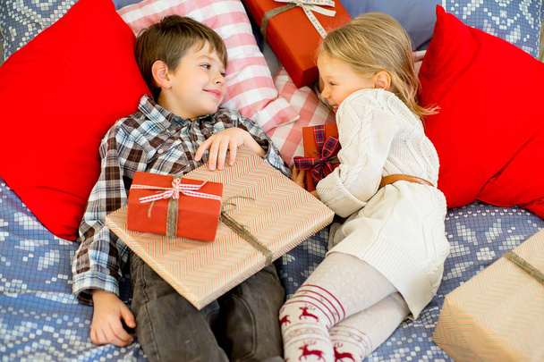 brother and sister are considering Christmas presents - 写真・画像
