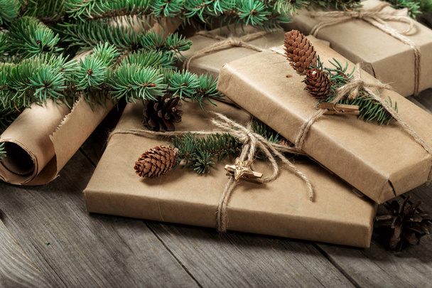 Bunch of Christmas presents with christmas tree branch and cone - Fotografie, Obrázek