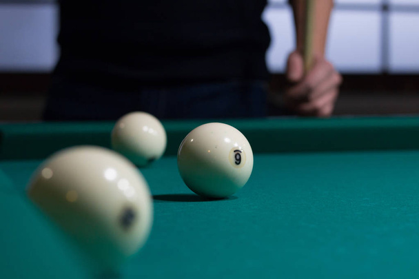 Russian billiards balls on green game table cloth and player - Photo, Image