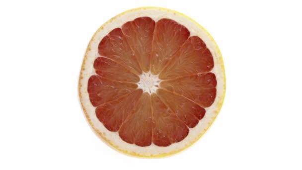 Sliced grapefruit rotating against White - Metraje, vídeo